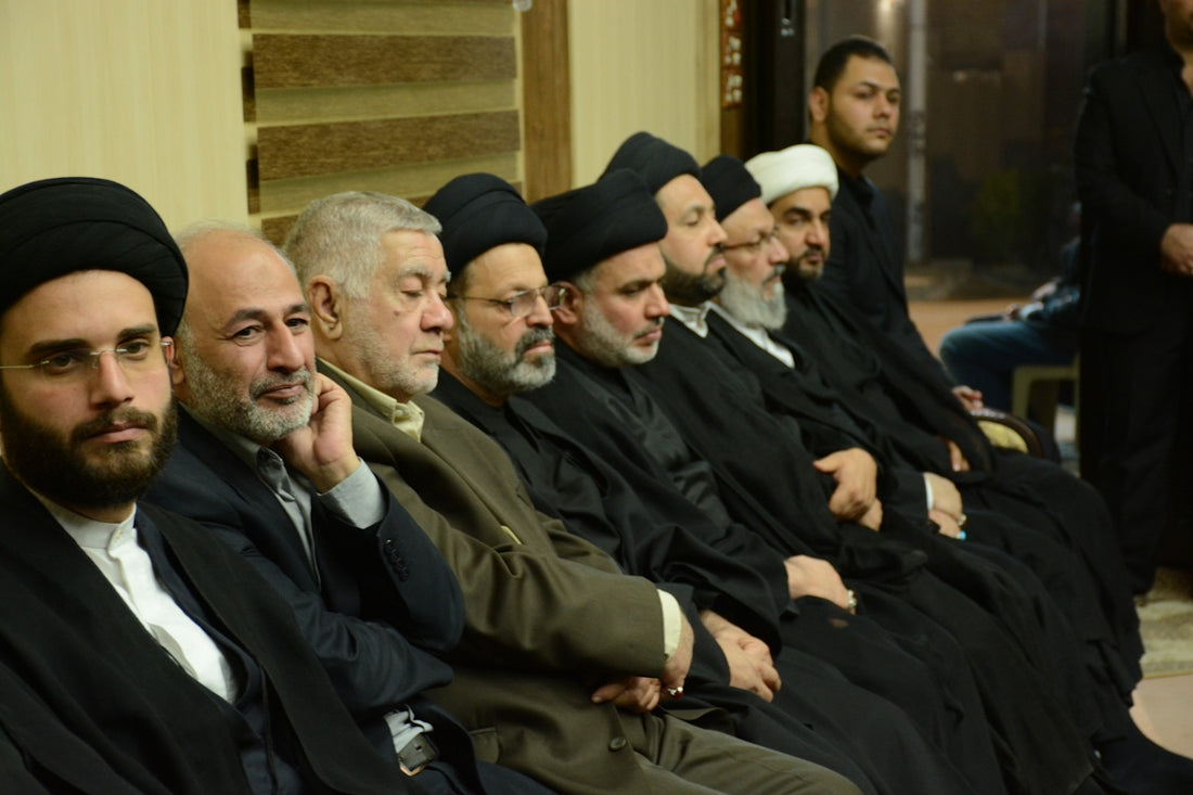 A group of men in religious attire are seated