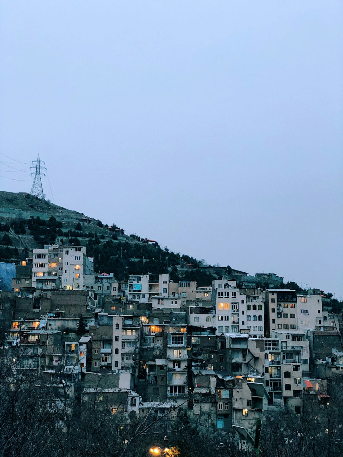 city with high rise buildings under gray sky during daytime