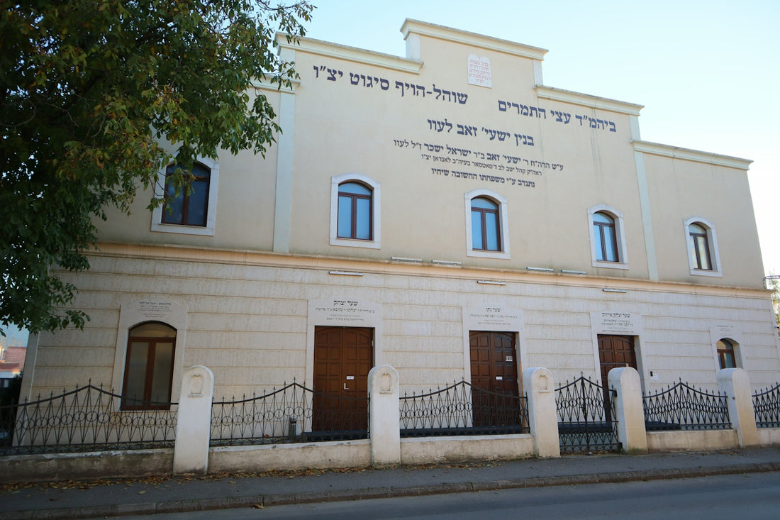 A large white building with a fence around it