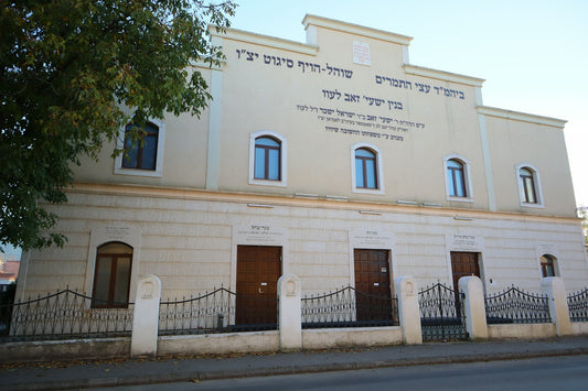A large white building with a fence around it