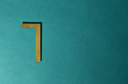 A gold right angle on a teal background.