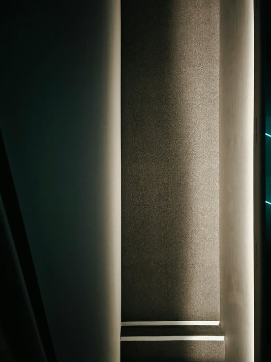 Textured fabric illuminated by soft light with white stripes.