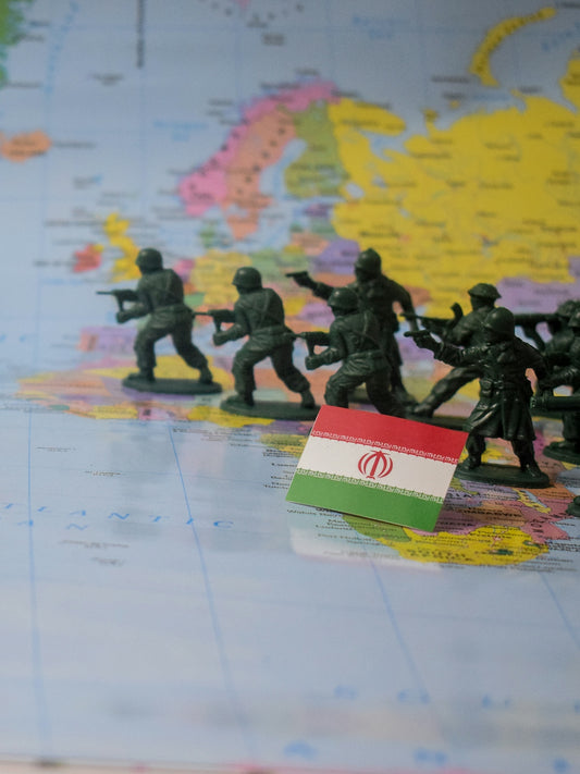 Toy soldiers advance on iran flag on map